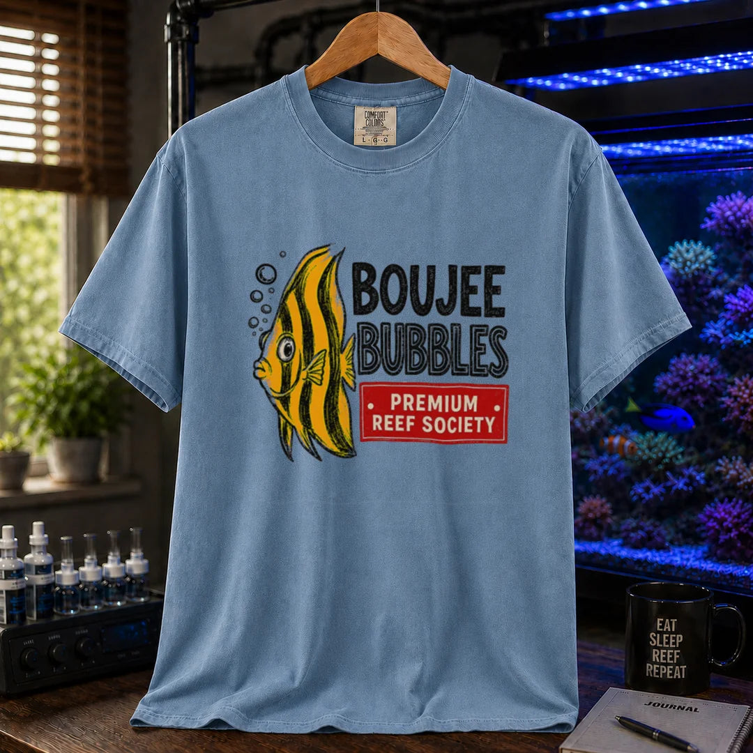 Saltwater aquarium graphic t-shirt featuring an illustration of a yellow striped fish blowing bubbles next to text reading Boujee Bubbles Premium Reef Society on a blue shirt