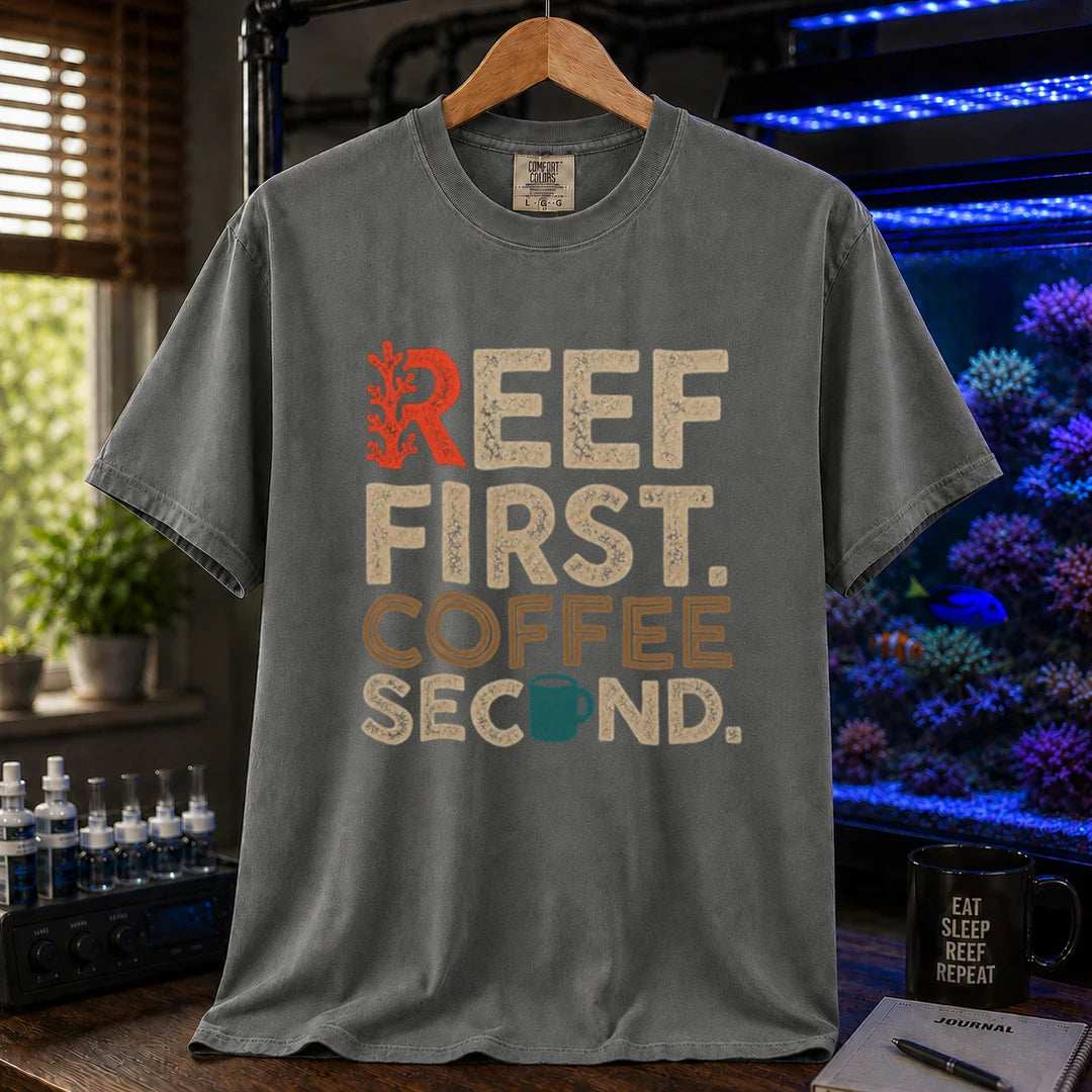 Saltwater aquarium graphic t-shirt featuring distressed typography reading Reef First Coffee Second with a red coral graphic and teal coffee mug icon on a grey shirt