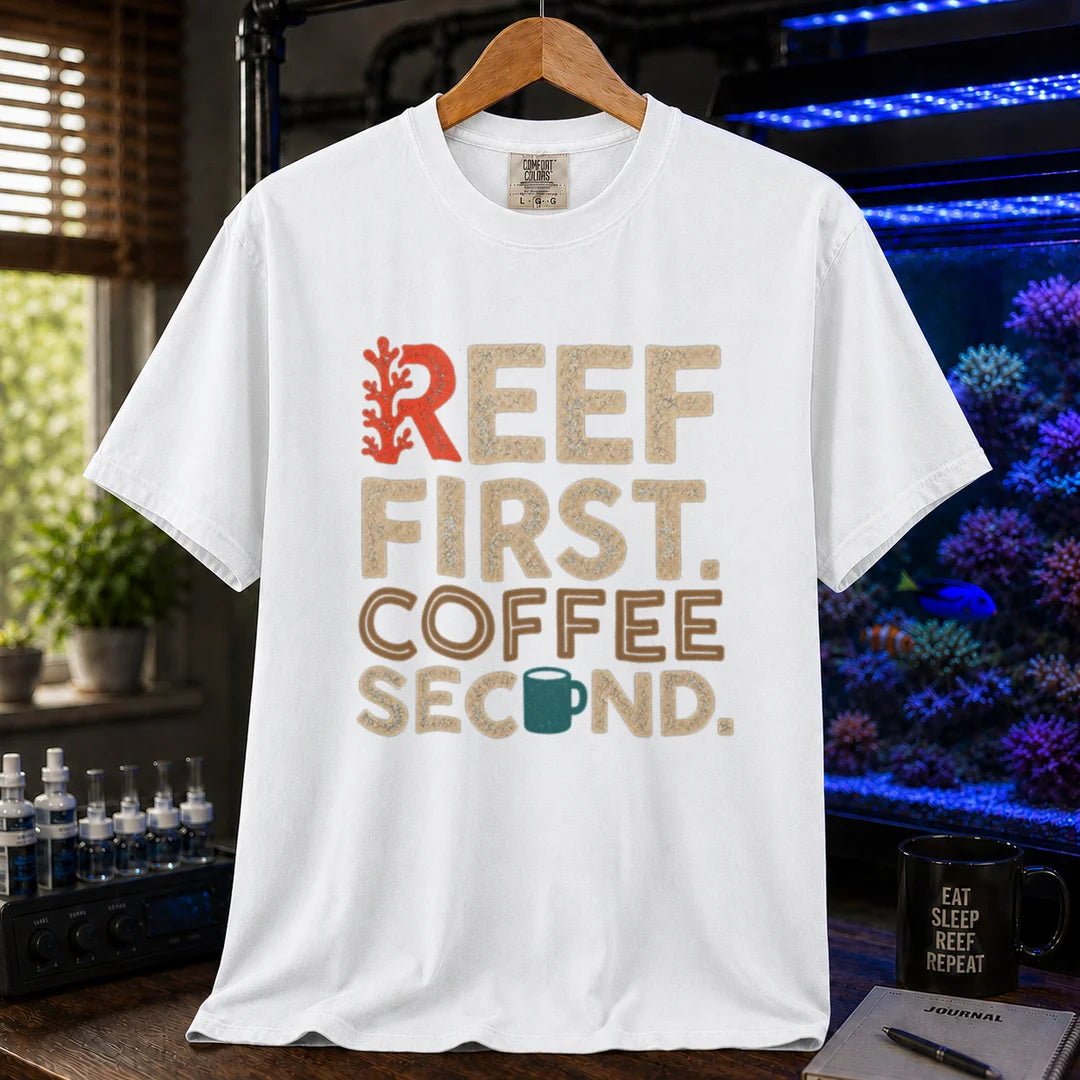 Saltwater aquarium graphic t-shirt featuring distressed typography reading Reef First Coffee Second with a red coral graphic and teal coffee mug icon on a white shirt