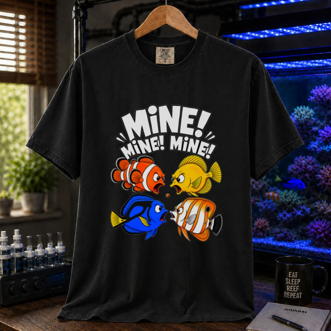 Saltwater aquarium graphic t-shirt featuring text reading Mine Mine Mine above four colorful reef fish fighting over a single piece of food on a black shirt