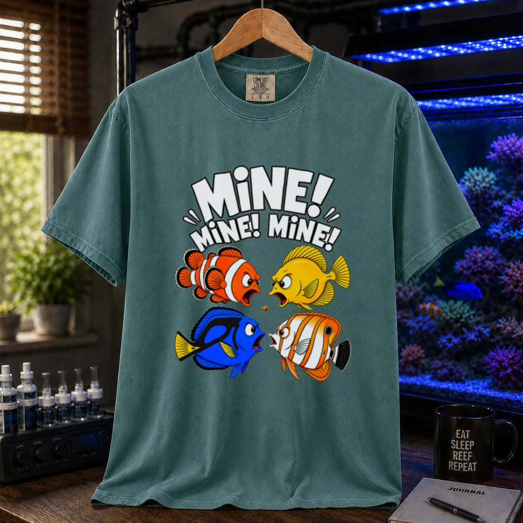 Saltwater aquarium graphic t-shirt featuring text reading Mine Mine Mine above four colorful reef fish fighting over a single piece of food on a green shirt