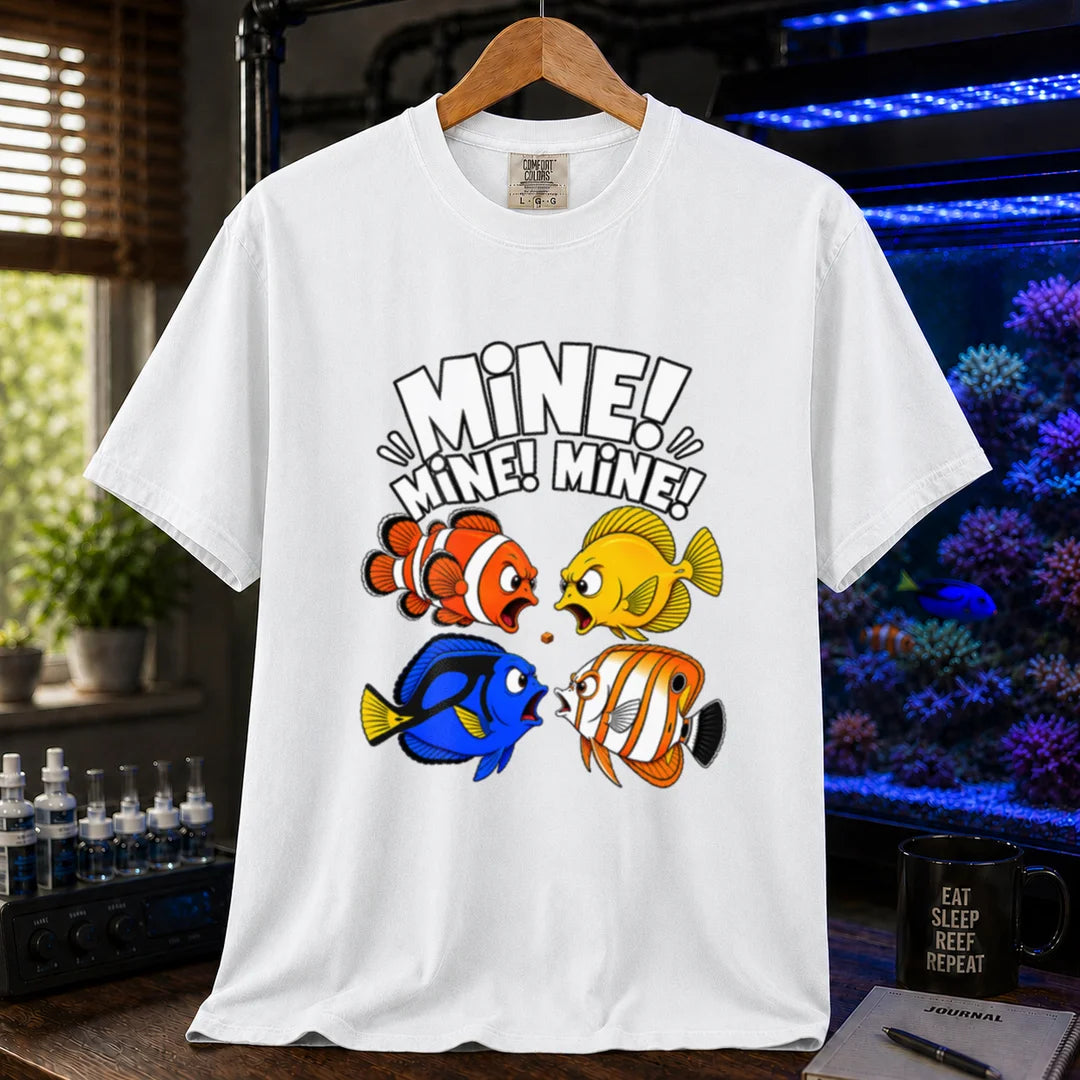 Saltwater aquarium graphic t-shirt featuring text reading Mine Mine Mine above four colorful reef fish fighting over a single piece of food on a white shirt
