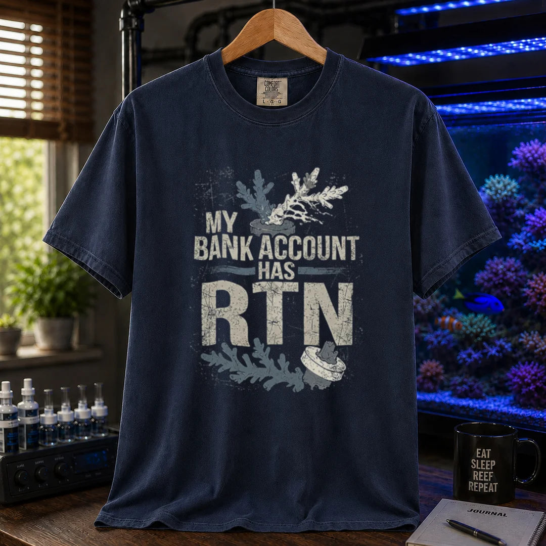 Saltwater aquarium graphic t-shirt featuring distressed typography reading My Bank Account Has RTN alongside dying coral frag illustrations on a navy shirt