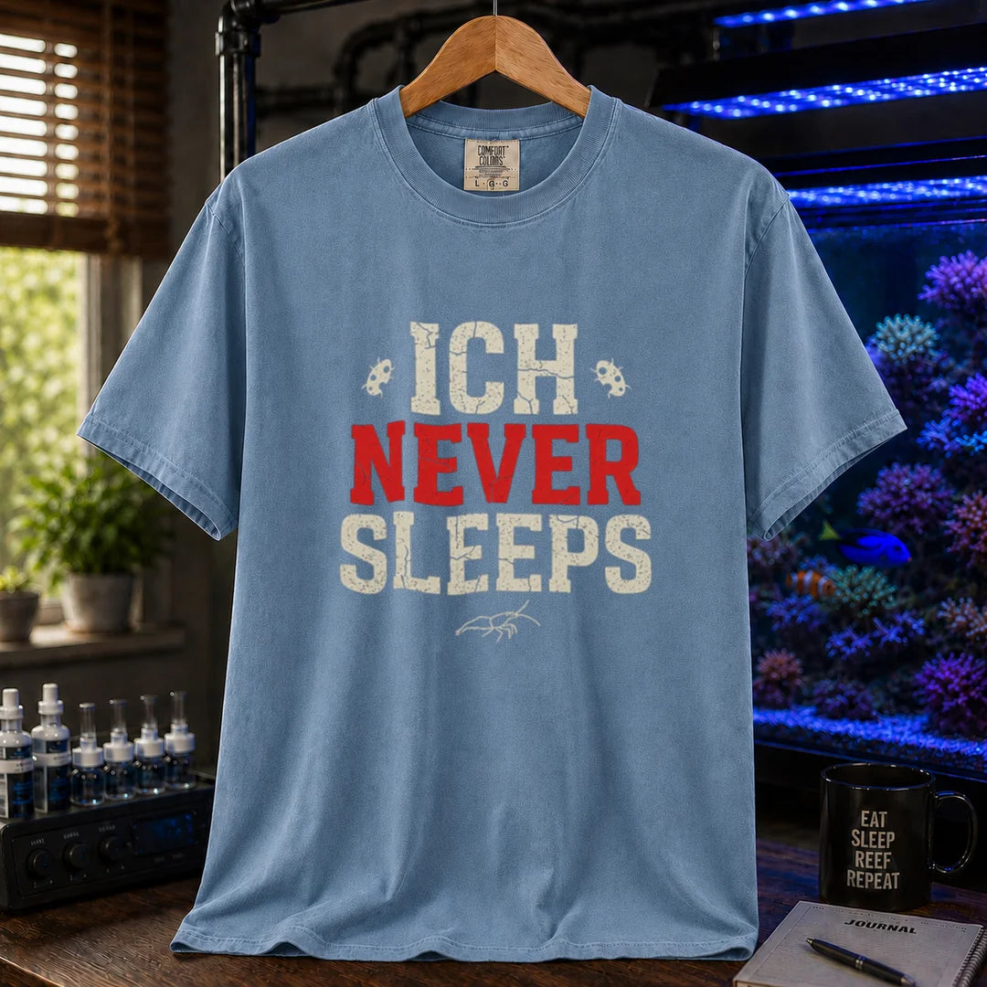 Saltwater aquarium graphic t-shirt featuring distressed typography reading Ich Never Sleeps in white and red with parasite icons on a blue shirt