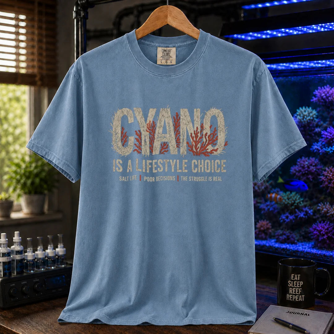 Saltwater aquarium graphic t-shirt featuring distressed typography reading Cyano Is A Lifestyle Choice with red algae details on a blue shirt