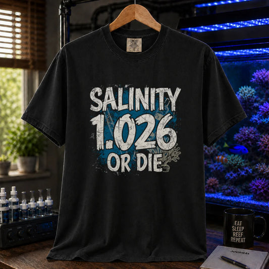 Saltwater aquarium graphic t-shirt featuring distressed typography reading Salinity 1.026 Or Die with a blue splatter background on a black shirt