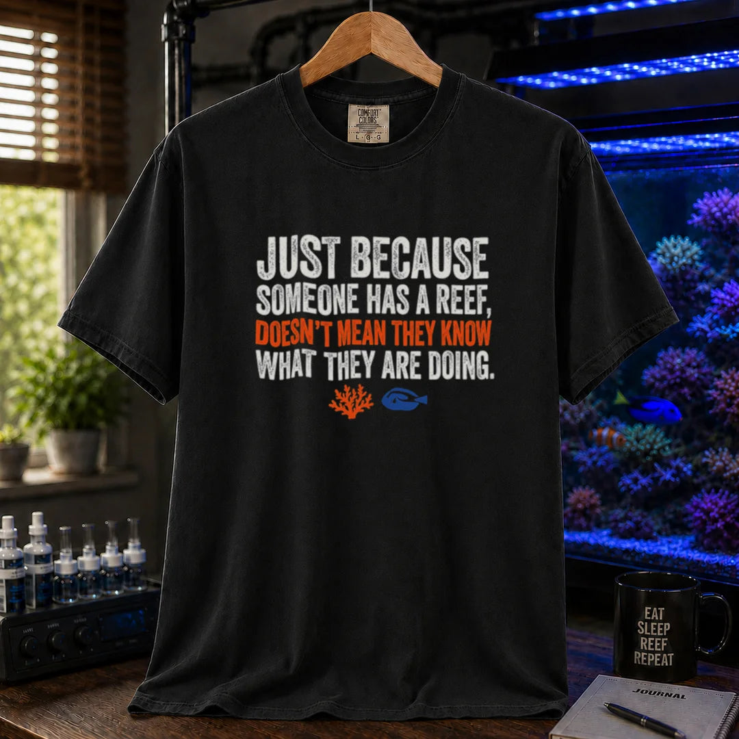 Saltwater aquarium graphic t-shirt featuring distressed white and orange typography reading Just Because Someone Has A Reef, Doesn't Mean They Know What They Are Doing on a black shirt