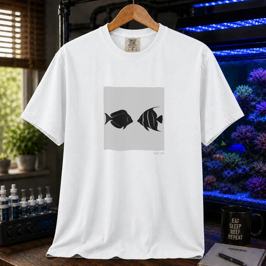 Saltwater aquarium graphic t-shirt featuring a minimalist square block with two silhouetted fish facing each other and small text reading Reef Life on a white shirt