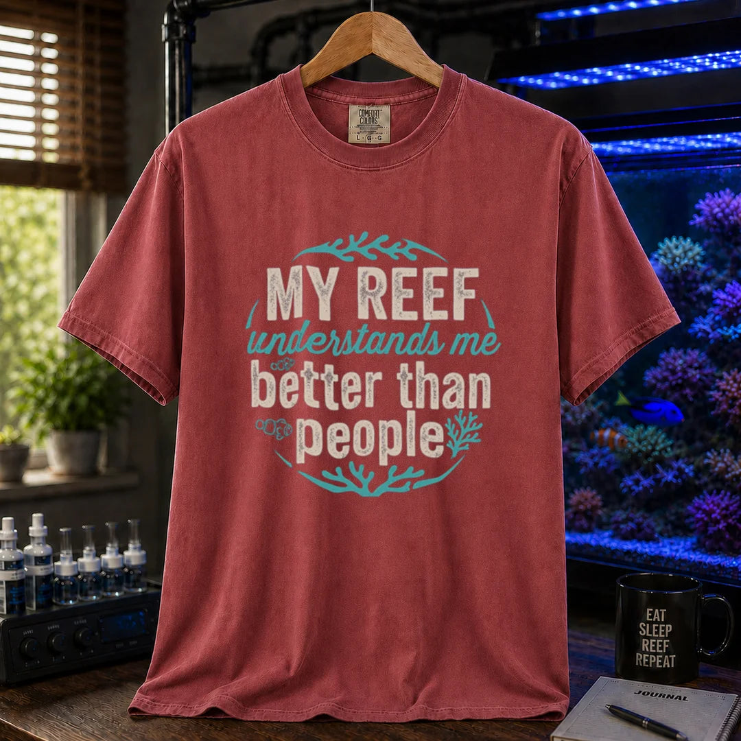 Saltwater aquarium graphic t-shirt featuring distressed circular typography reading My Reef Understands Me Better Than People with clownfish and coral graphics on a maroon, red shirt