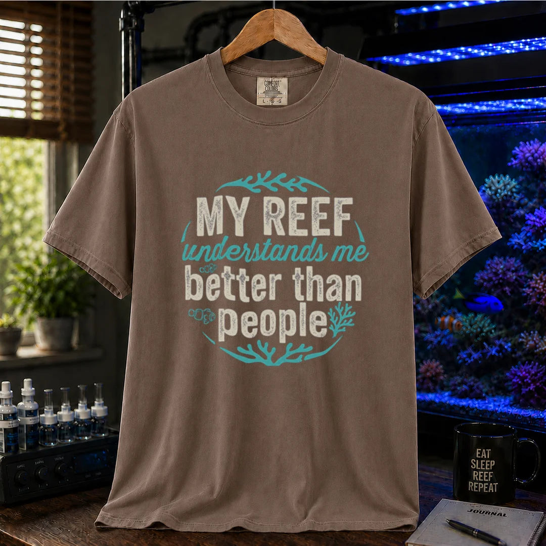 Saltwater aquarium graphic t-shirt featuring distressed circular typography reading My Reef Understands Me Better Than People with clownfish and coral graphics on a brown shirt