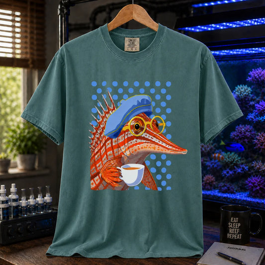 Saltwater aquarium graphic t-shirt featuring a longnose hawkfish wearing a beret and glasses while holding a teacup against a blue polka dot background on a green shirt