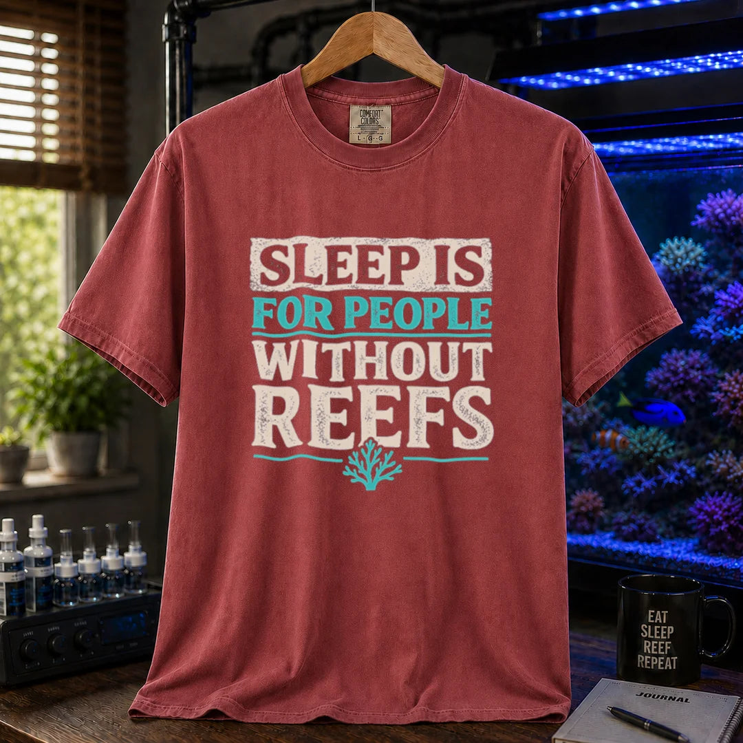 Saltwater aquarium graphic t-shirt featuring distressed typography reading Sleep Is For People Without Reefs with a coral icon on a maroon, red shirt