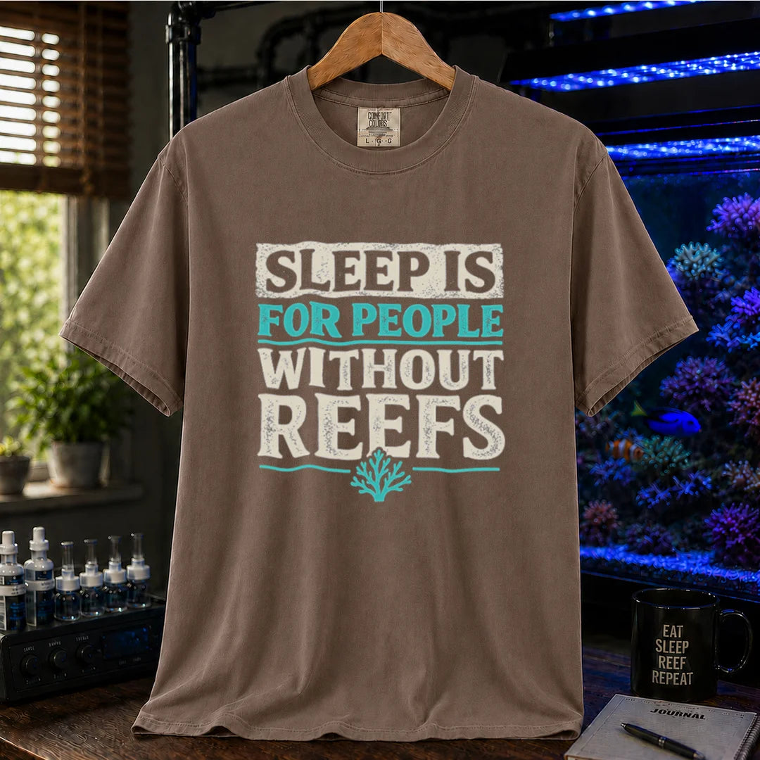 Saltwater aquarium graphic t-shirt featuring distressed typography reading Sleep Is For People Without Reefs with a coral icon on a brown shirt