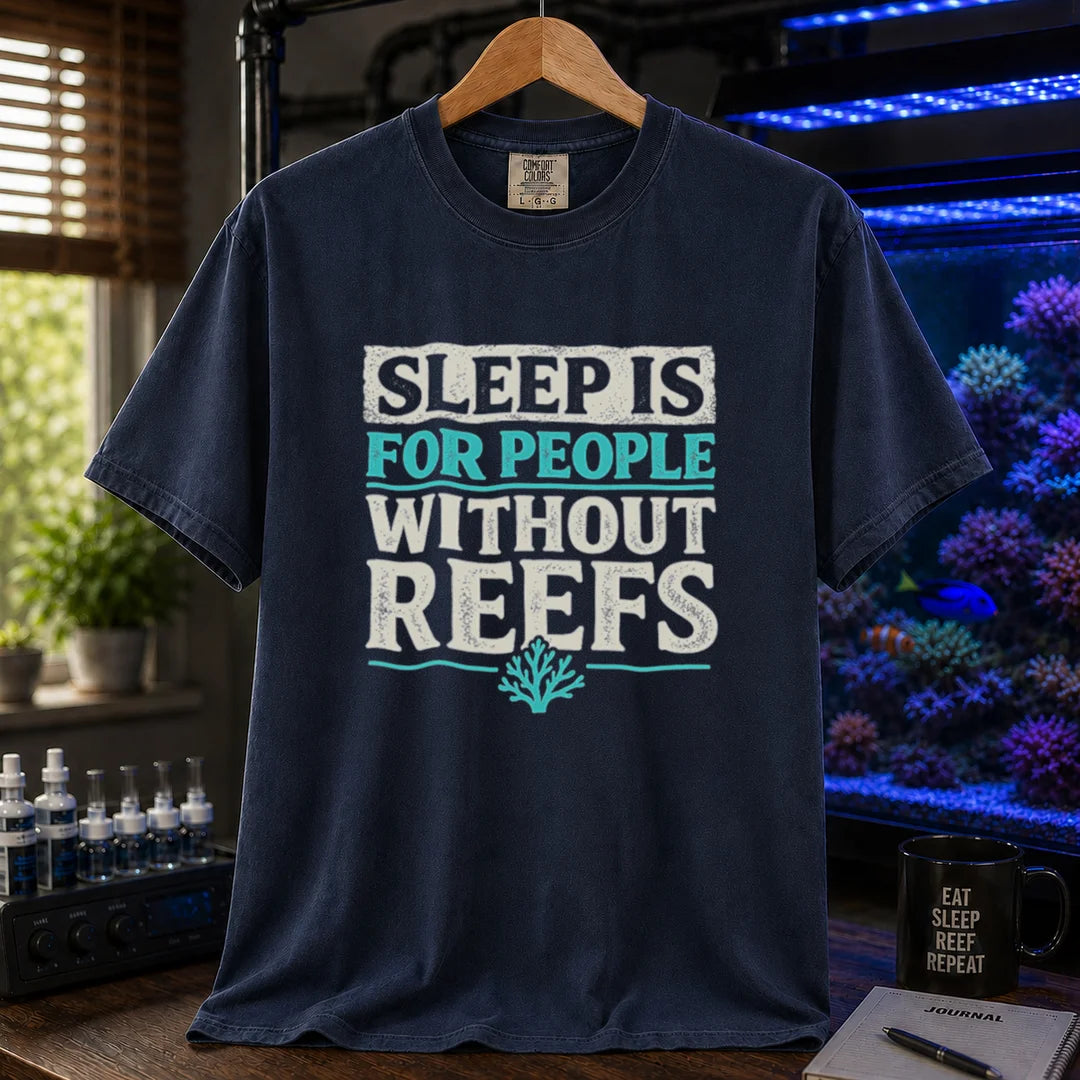 Saltwater aquarium graphic t-shirt featuring distressed typography reading Sleep Is For People Without Reefs with a coral icon on a navy shirt