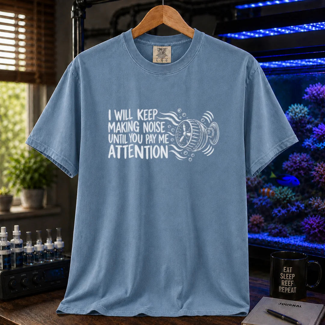 Saltwater aquarium graphic t-shirt featuring distressed typography reading I Will Keep Making Noise Until You Pay Me Attention with an aquarium wavemaker pump illustration on a blue shirt