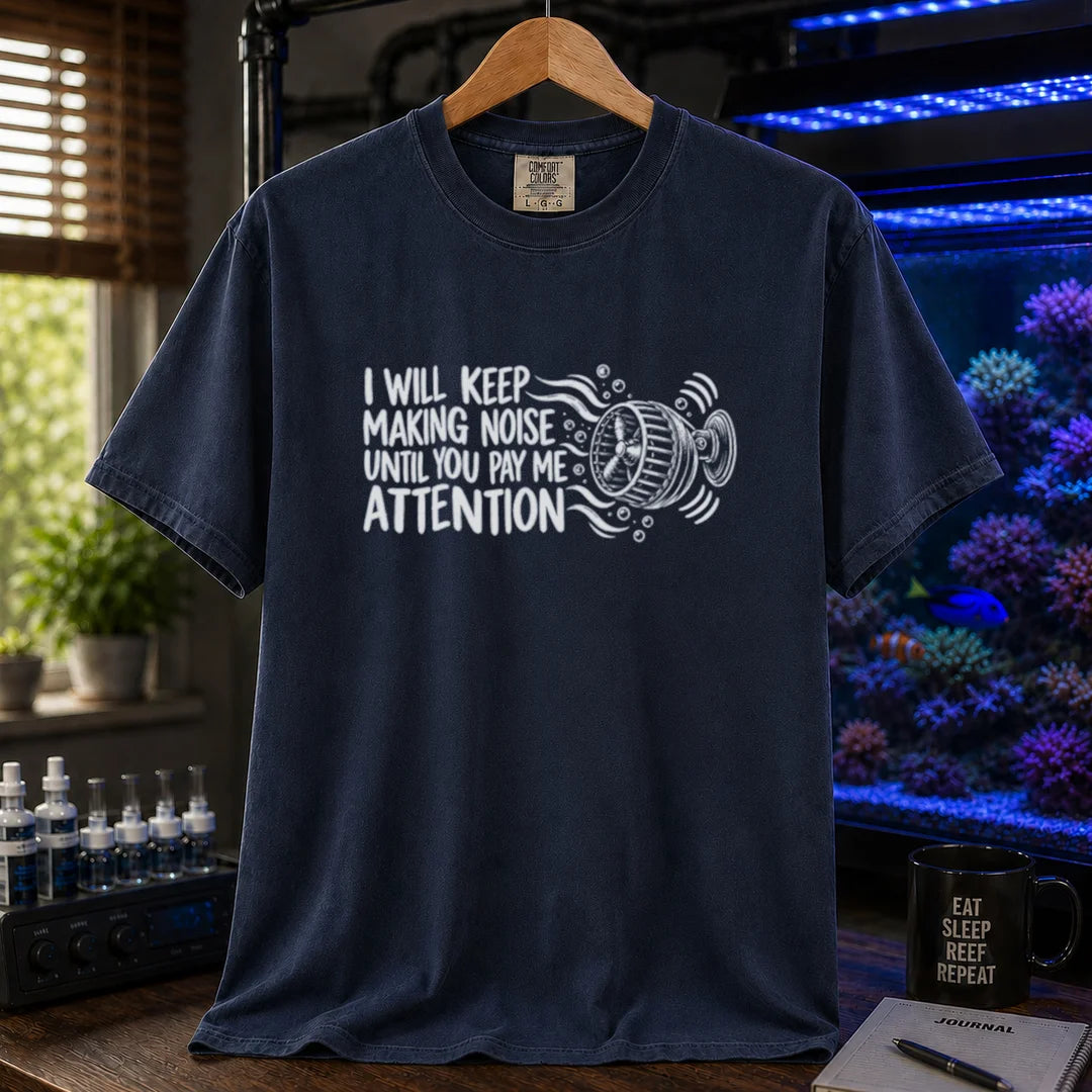 Saltwater aquarium graphic t-shirt featuring distressed typography reading I Will Keep Making Noise Until You Pay Me Attention with an aquarium wavemaker pump illustration on a navy shirt