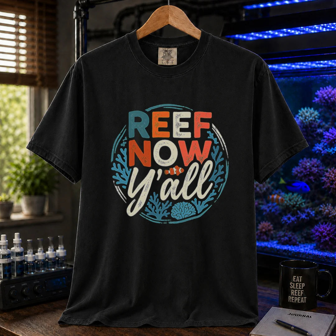 Saltwater aquarium graphic t-shirt featuring a circular distressed emblem with typography reading Reef Now Y'all and a clownfish illustration on a black shirt