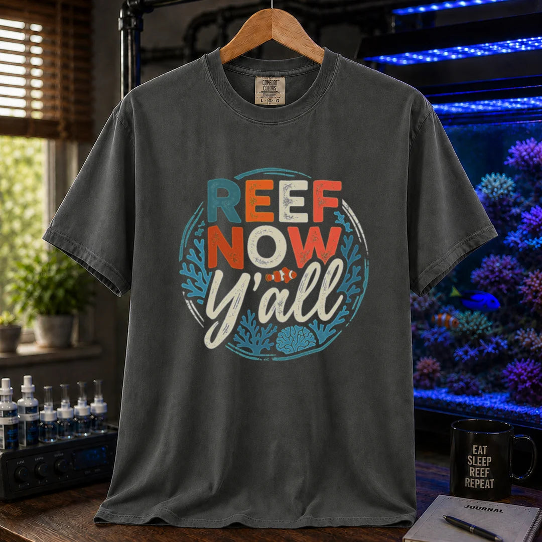 Saltwater aquarium graphic t-shirt featuring a circular distressed emblem with typography reading Reef Now Y'all and a clownfish illustration on a dark grey shirt
