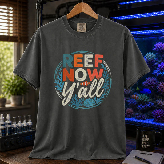 Saltwater aquarium graphic t-shirt featuring a circular distressed emblem with typography reading Reef Now Y'all and a clownfish illustration on a dark grey shirt