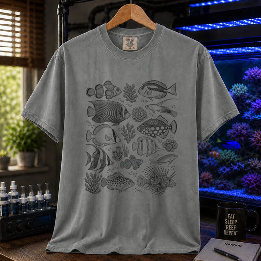 Saltwater aquarium graphic t-shirt featuring an intricate black-and-white stippled scientific illustration of various marine fish species and corals on a grey shirt
