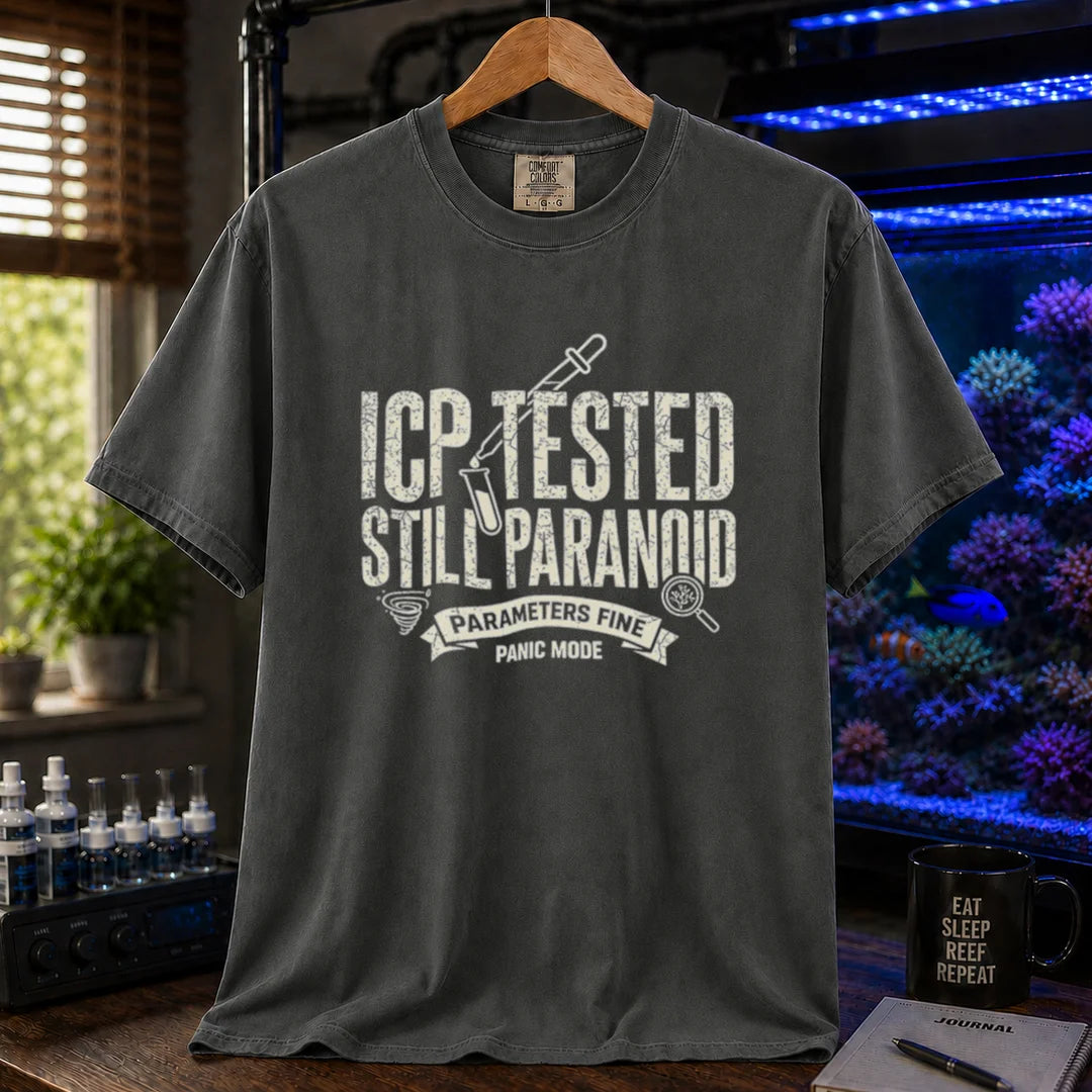 Saltwater aquarium graphic t-shirt featuring distressed typography reading ICP Tested Still Paranoid with a test tube icon and banner text reading Parameters Fine Panic Mode on a dark grey shirt