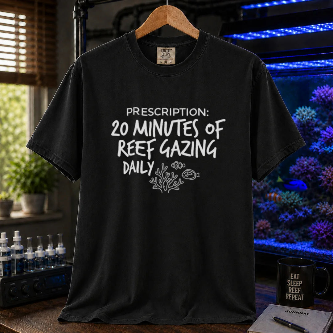 Saltwater aquarium graphic t-shirt featuring distressed handwritten typography reading Prescription: 20 Minutes Of Reef Gazing Daily with a coral and fish illustration on a black shirt