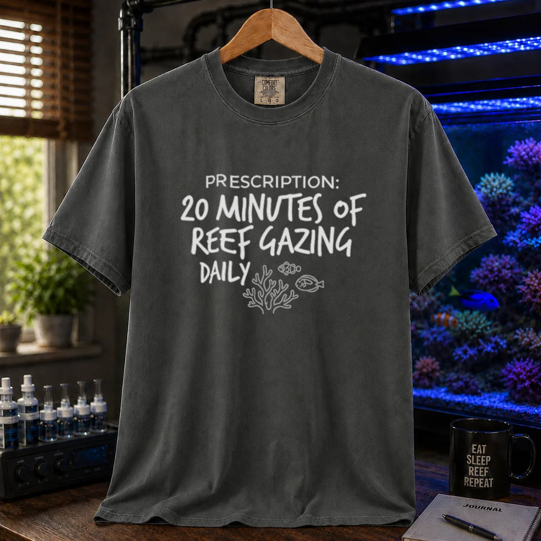 Saltwater aquarium graphic t-shirt featuring distressed handwritten typography reading Prescription: 20 Minutes Of Reef Gazing Daily with a coral and fish illustration on a dark grey shirt