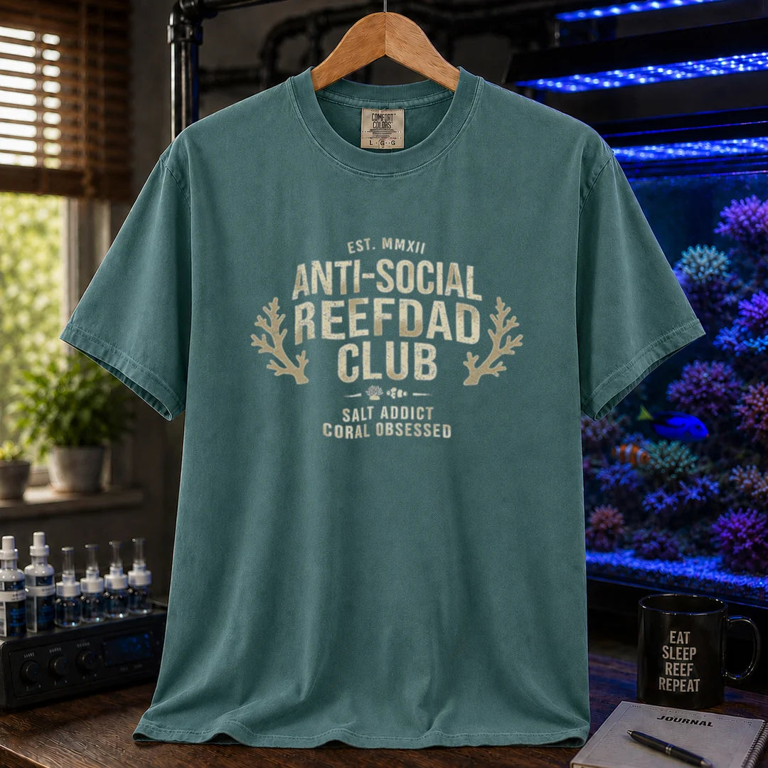Saltwater aquarium graphic t-shirt featuring a vintage athletic crest with typography reading Anti-Social Reefdad Club and coral illustrations on a green shirt