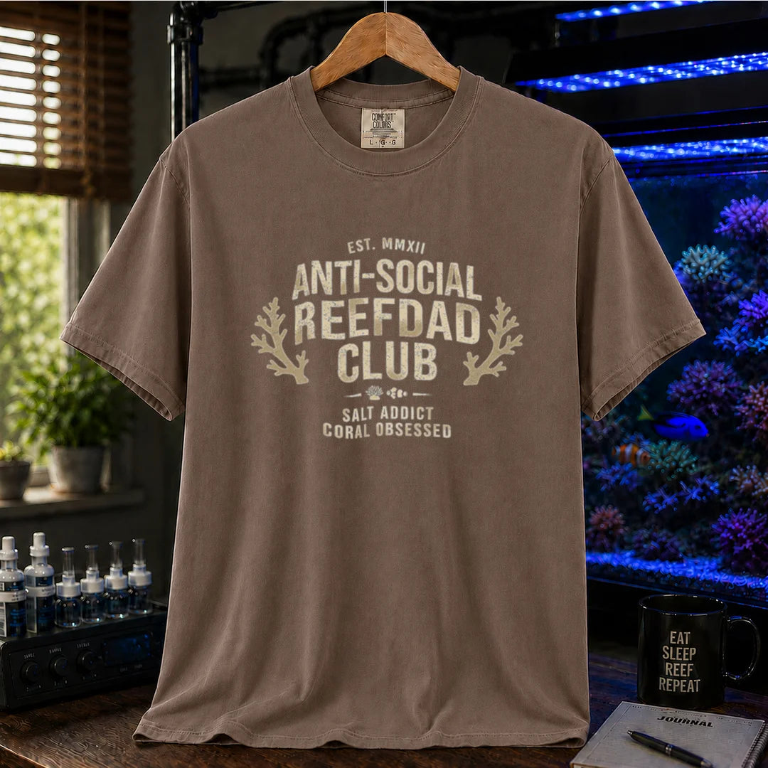 Saltwater aquarium graphic t-shirt featuring a vintage athletic crest with typography reading Anti-Social Reefdad Club and coral illustrations on a brown shirt