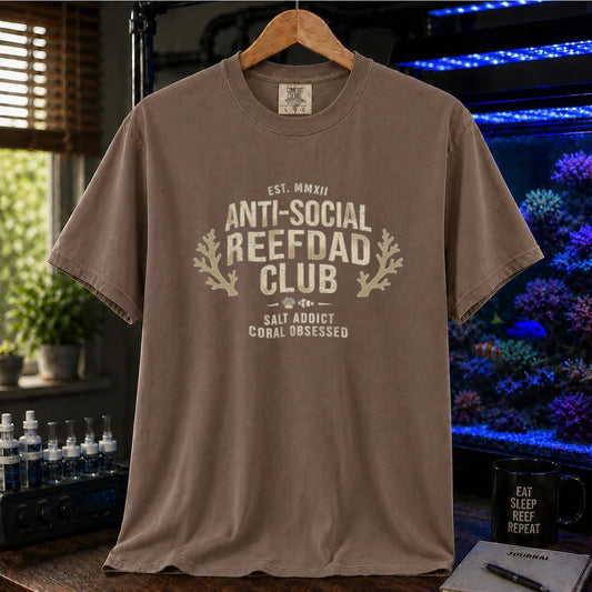Saltwater aquarium graphic t-shirt featuring a vintage athletic crest with typography reading Anti-Social Reefdad Club and coral illustrations on a brown shirt