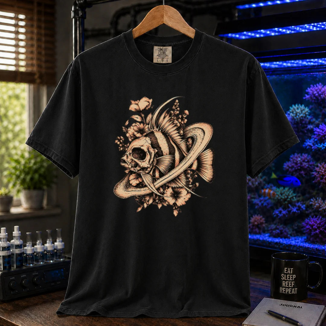 Saltwater aquarium graphic t-shirt featuring an intricate sepia line-art illustration of a fish skull surrounded by flowers and swirling rings on a black shirt