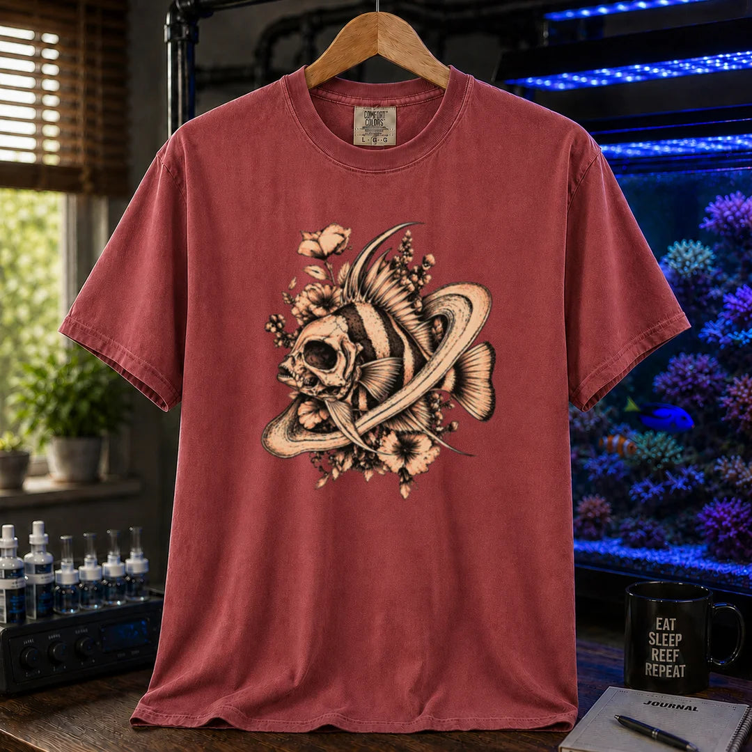 Saltwater aquarium graphic t-shirt featuring an intricate sepia line-art illustration of a fish skull surrounded by flowers and swirling rings on a maroon, red shirt