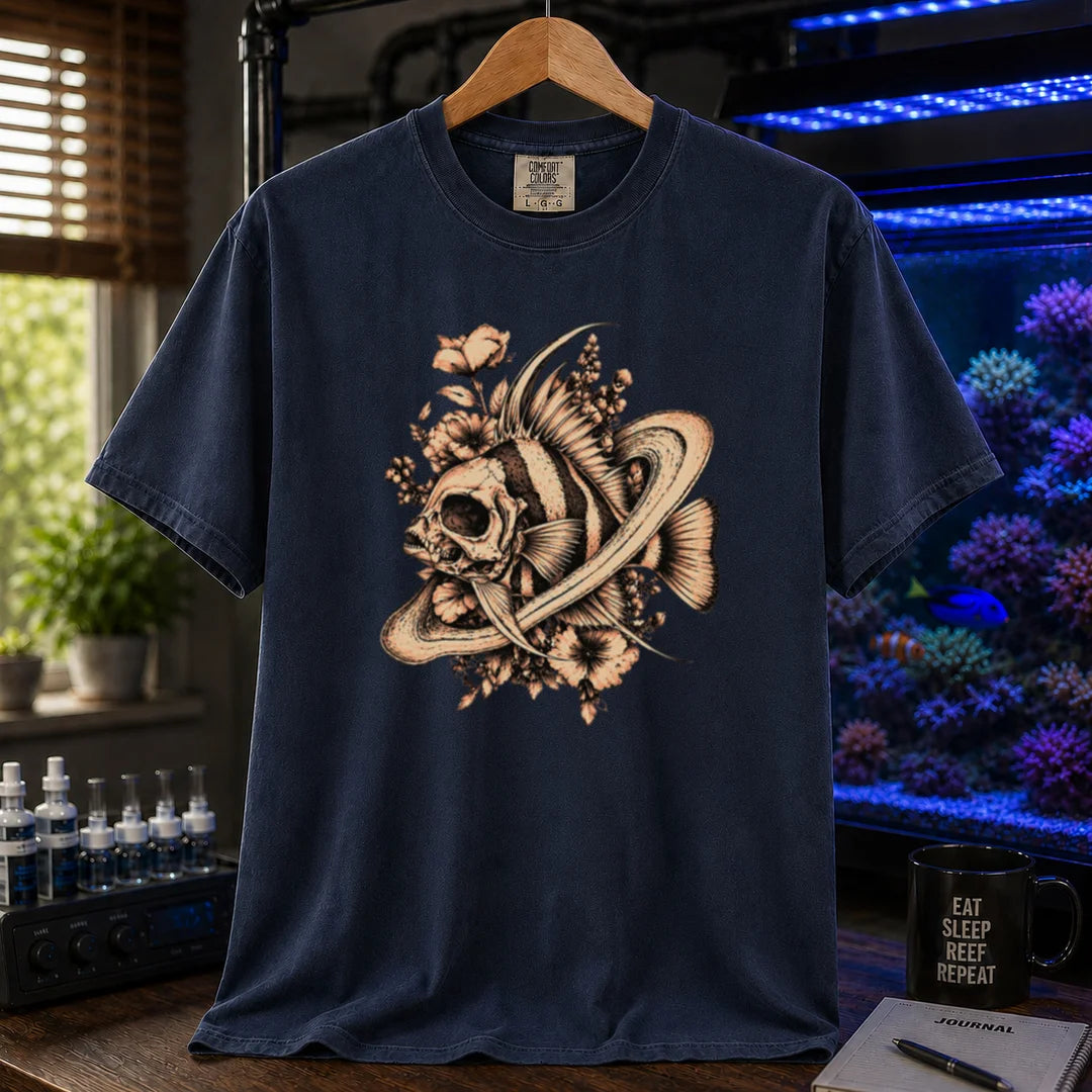 Saltwater aquarium graphic t-shirt featuring an intricate sepia line-art illustration of a fish skull surrounded by flowers and swirling rings on a navy shirt