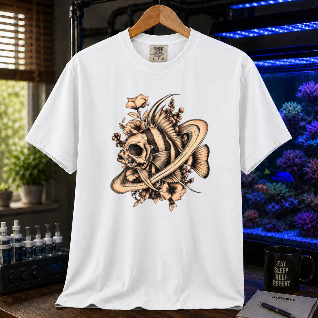 Saltwater aquarium graphic t-shirt featuring an intricate sepia line-art illustration of a fish skull surrounded by flowers and swirling rings on a white shirt