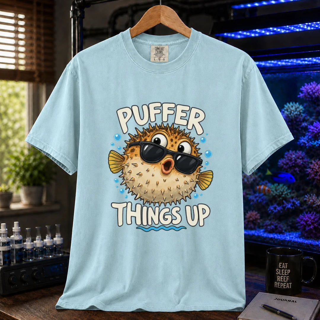 White saltwater aquarium graphic t-shirt featuring typography reading Puffer Things Up framing an illustration of a pufferfish wearing sunglasses on a light blue shirt