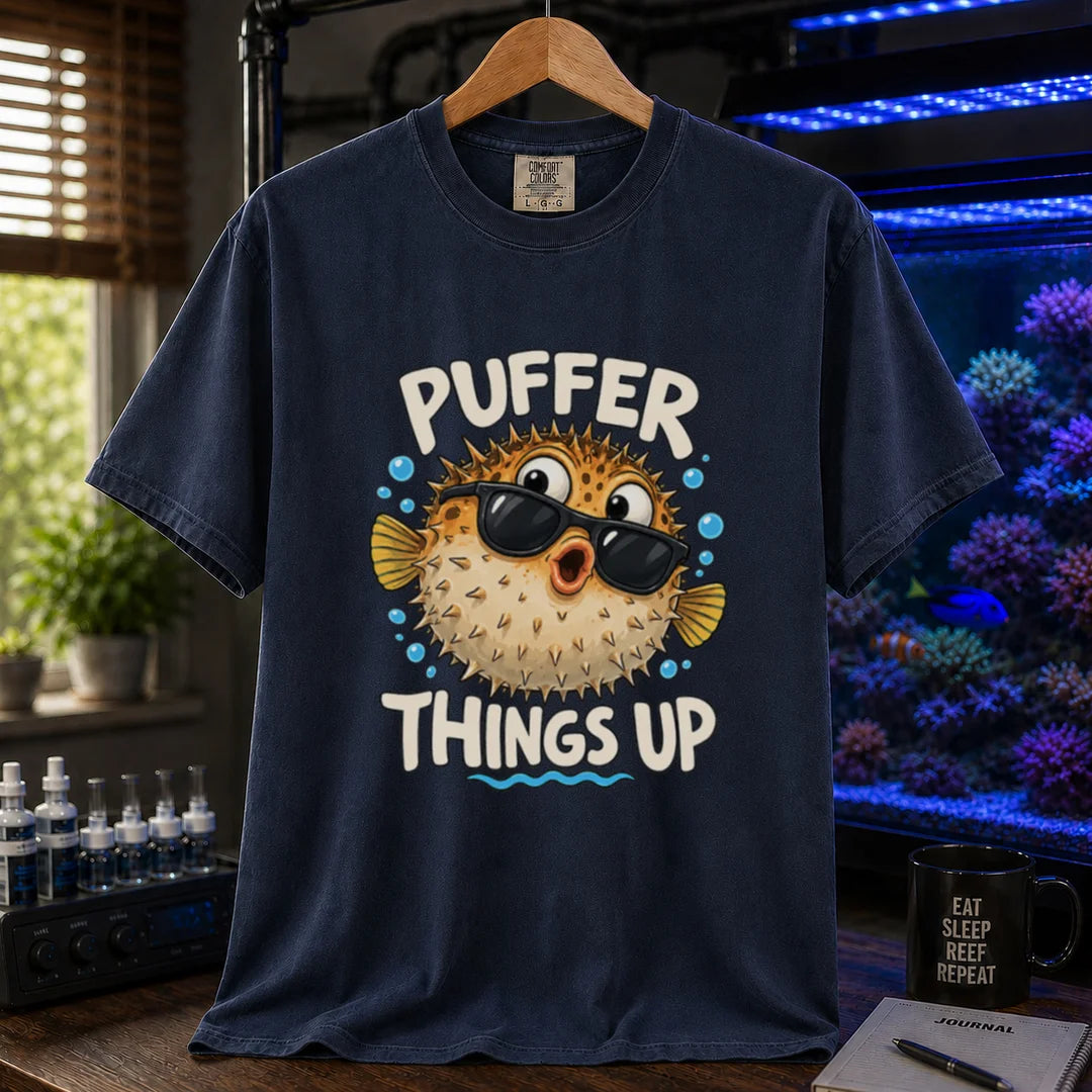 White saltwater aquarium graphic t-shirt featuring typography reading Puffer Things Up framing an illustration of a pufferfish wearing sunglasses on a navy shirt