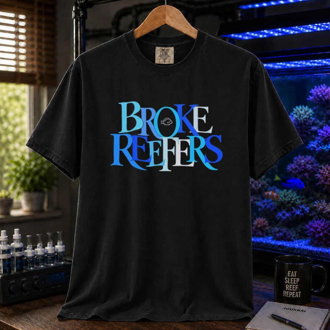 Saltwater aquarium graphic t-shirt featuring overlapping blue and white serif typography spelling Broke Reefers with a small fish outline on a black shirt