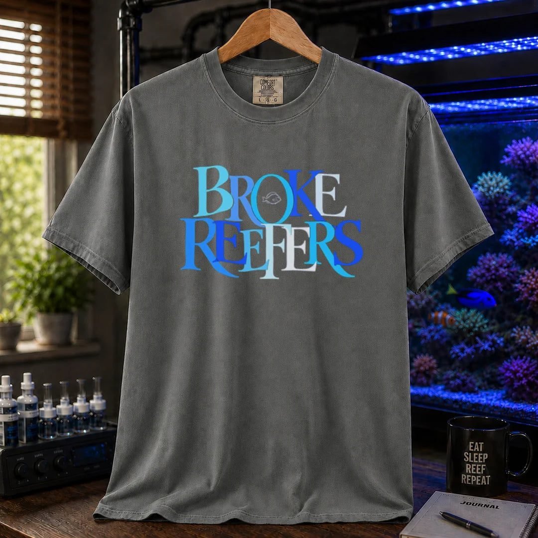 Saltwater aquarium graphic t-shirt featuring overlapping blue and white serif typography spelling Broke Reefers with a small fish outline on a grey shirt