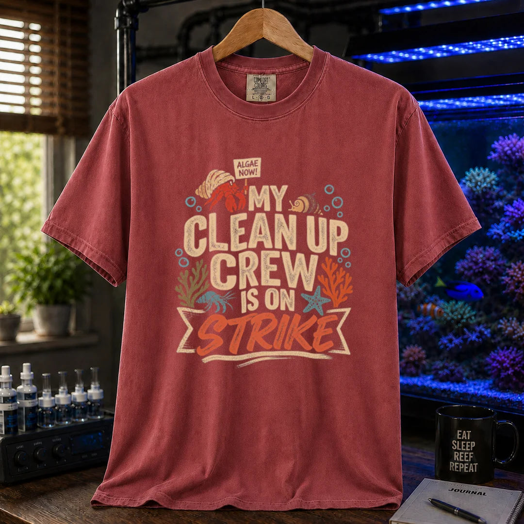 Saltwater aquarium graphic t-shirt featuring distressed typography reading My Clean Up Crew Is On Strike with illustrations of a hermit crab holding a protest sign and other marine cleanup animals on a maroon, red T-Shirt