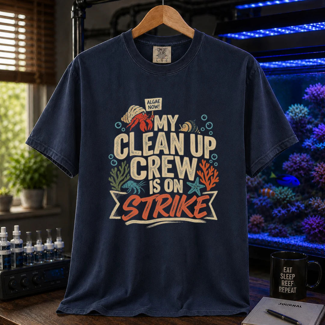 Saltwater aquarium graphic t-shirt featuring distressed typography reading My Clean Up Crew Is On Strike with illustrations of a hermit crab holding a protest sign and other marine cleanup animals on a navy T-Shirt