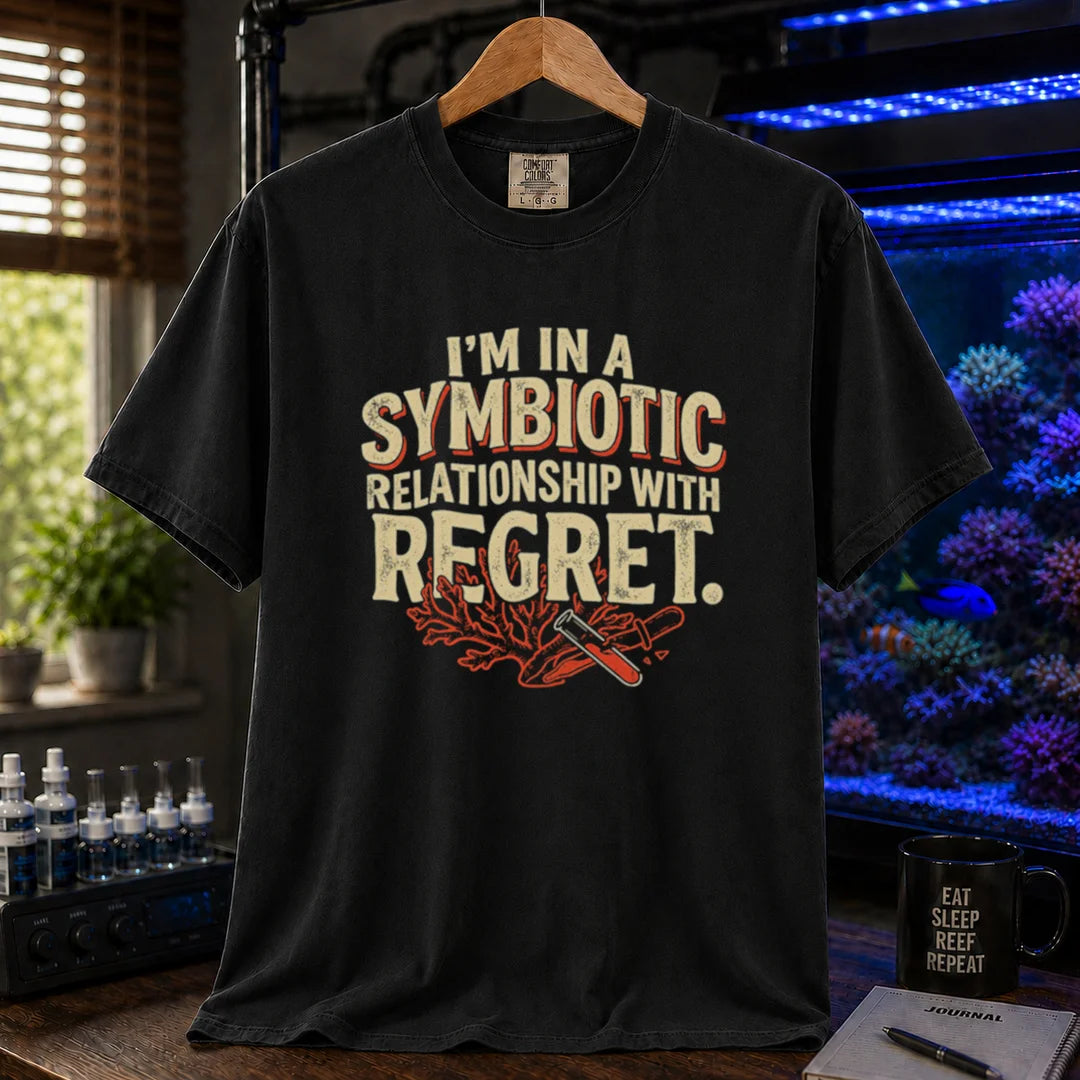 Saltwater aquarium graphic t-shirt featuring distressed typography reading I'm In A Symbiotic Relationship With Regret with coral and pipette illustrations on a black T-Shirt