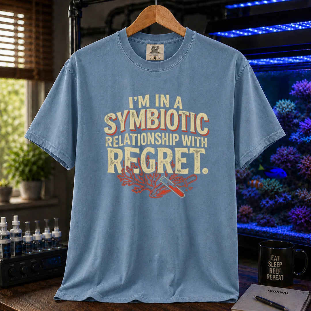 Saltwater aquarium graphic t-shirt featuring distressed typography reading I'm In A Symbiotic Relationship With Regret with coral and pipette illustrations on a blue T-Shirt