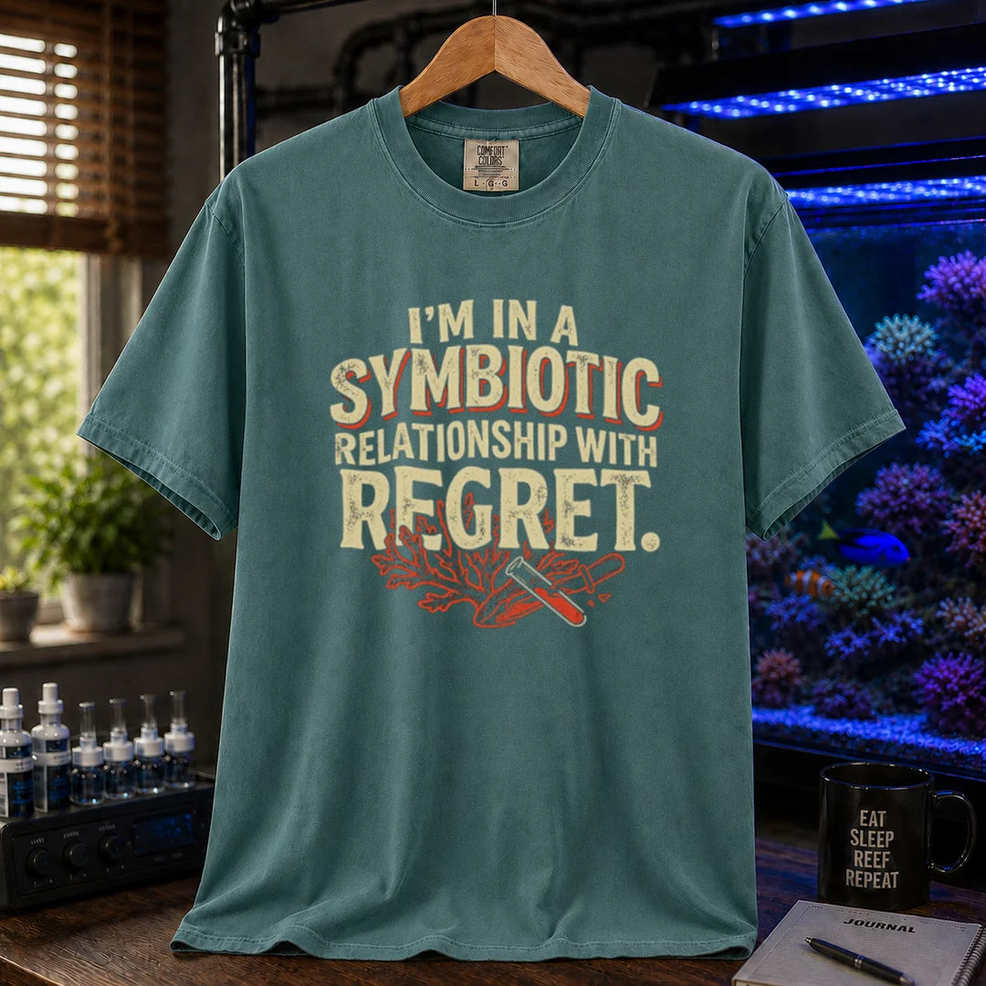 Saltwater aquarium graphic t-shirt featuring distressed typography reading I'm In A Symbiotic Relationship With Regret with coral and pipette illustrations on a green T-Shirt