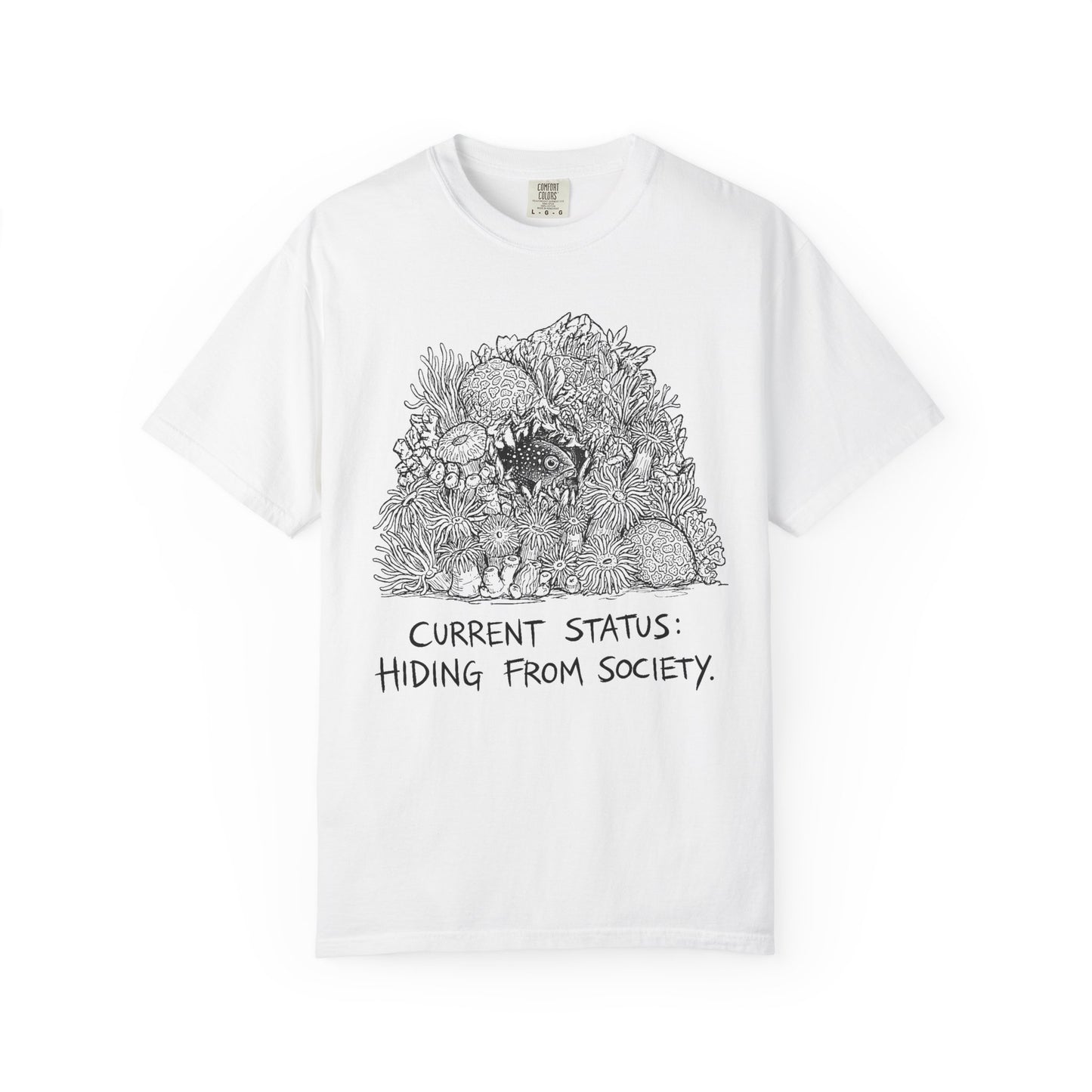CURRENT STATUS: HIDING FROM SOCIETY graphic t-shirt design featuring bold distressed lettering and a detailed reef creature nestled within a colourful coral reef illustration.
