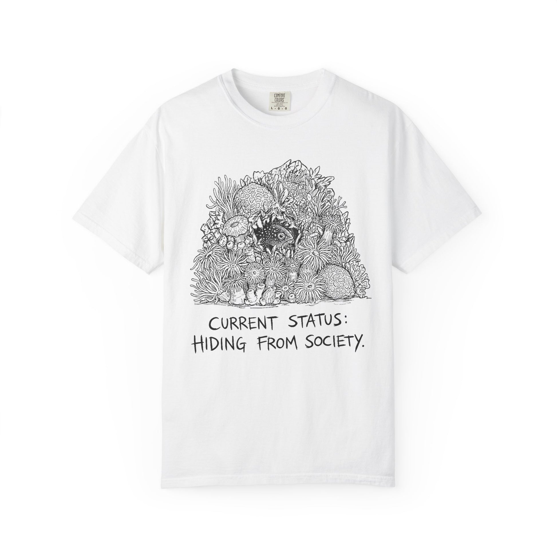 CURRENT STATUS: HIDING FROM SOCIETY graphic t-shirt design featuring bold distressed lettering and a detailed reef creature nestled within a colourful coral reef illustration.
