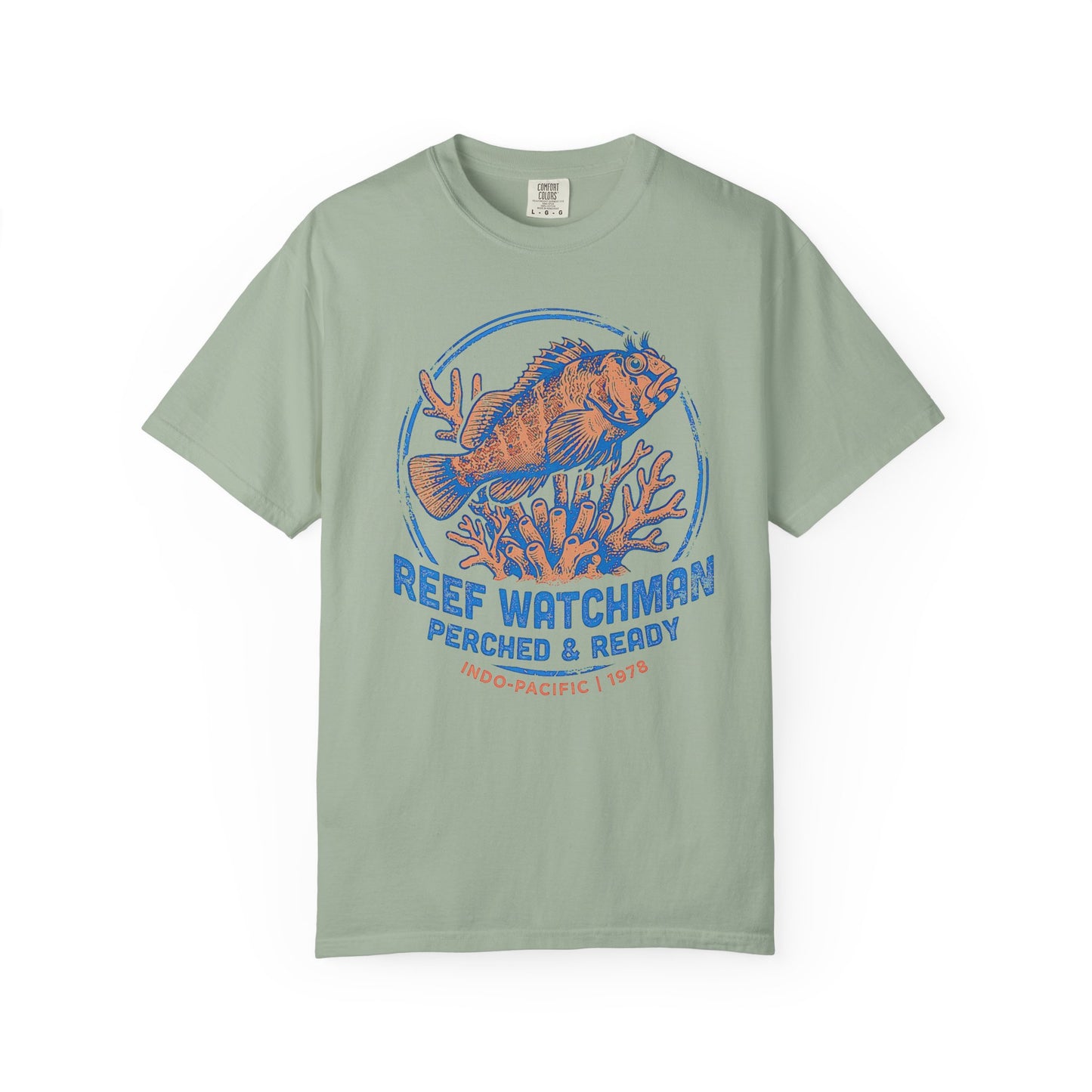 Broke Reefers saltwater aquarium graphic t-shirt featuring a detailed, vintage-style badge illustration of a blenny on coral with the text: REEF WATCHMAN PERCHED & READY INDO-PACIFIC | 1978, light green crew neck tee
