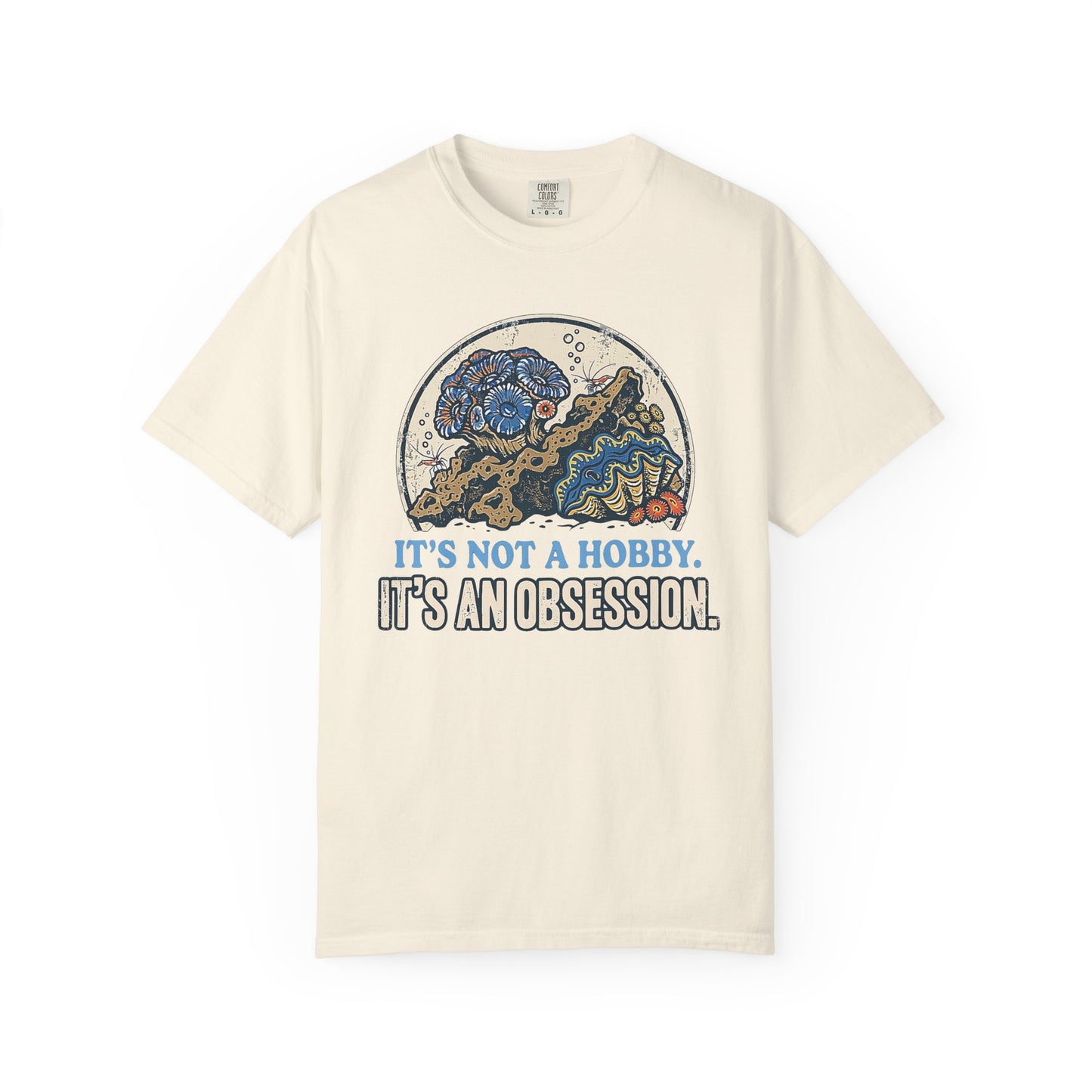 Broke Reefers saltwater aquarium graphic t-shirt featuring a detailed, vintage-style circular illustration of a thriving reef scene with the text: IT'S NOT A HOBBY. IT'S AN OBSESSION., beige cream crew neck tee