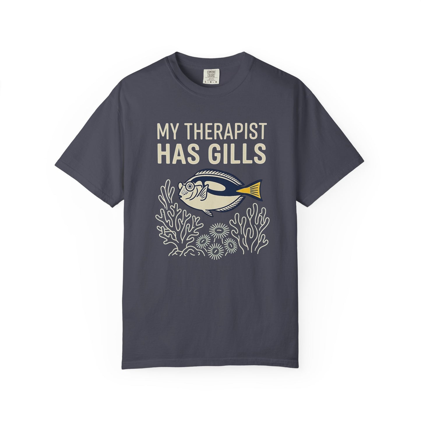MY THERAPIST HAS GILLS graphic t-shirt design featuring bold lettering and a colourful saltwater reef aquarium scene with a tropical fish illustration.