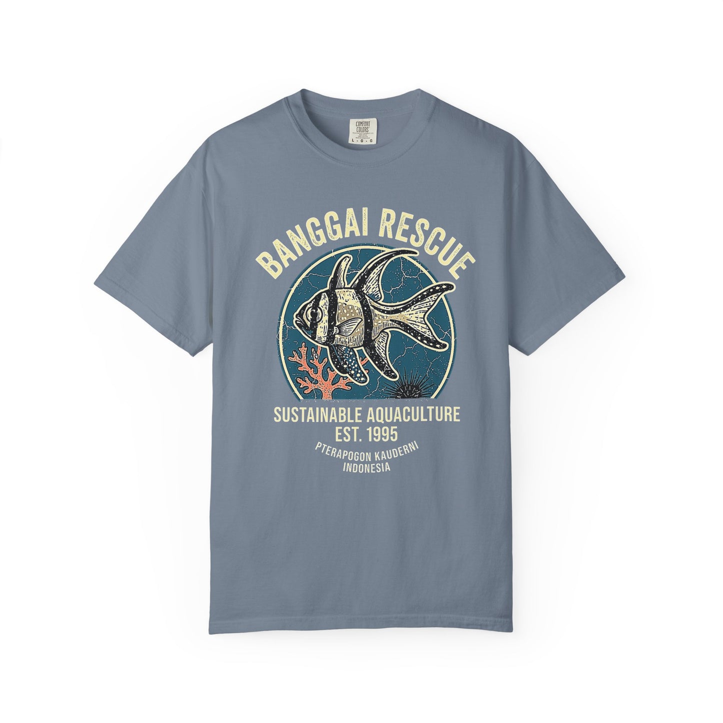 Broke Reefers saltwater aquarium graphic t-shirt featuring a detailed, vintage-style badge illustration of a Banggai Cardinalfish with the text: BANGGAI RESCUE SUSTAINABLE AQUACULTURE EST. 1995 PTERAPOGON KAUDERNI INDONESIA, blue crew neck tee