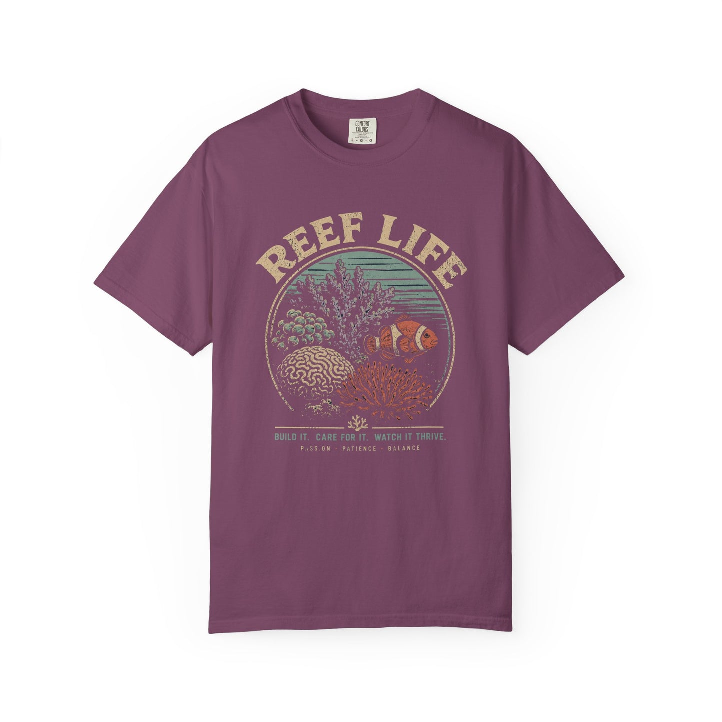 Broke Reefers saltwater aquarium graphic t-shirt featuring a vintage badge illustration of a thriving reef with the text: REEF LIFE. BUILD IT. CARE FOR IT. WATCH IT THRIVE. PASSION, PATIENCE, BALANCE, purple crew neck tee